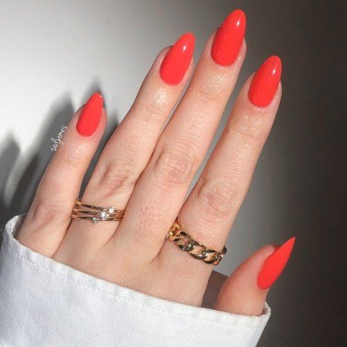 Bold Red Almond Nails with Gold Accents.