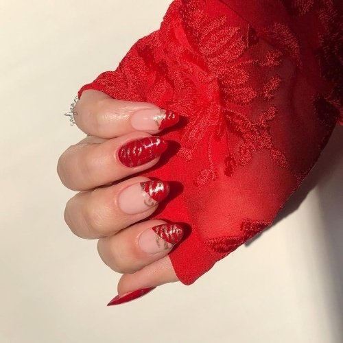 Elegant Red & Gold Swirl Nails with Nude Accents.