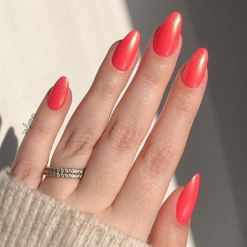 Soft Shimmer Red Nails with a Golden Glow