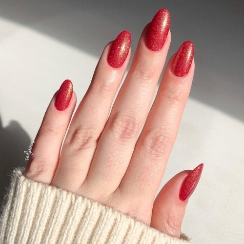 Sparkling Ruby Red Nails with a Holographic Touch.
